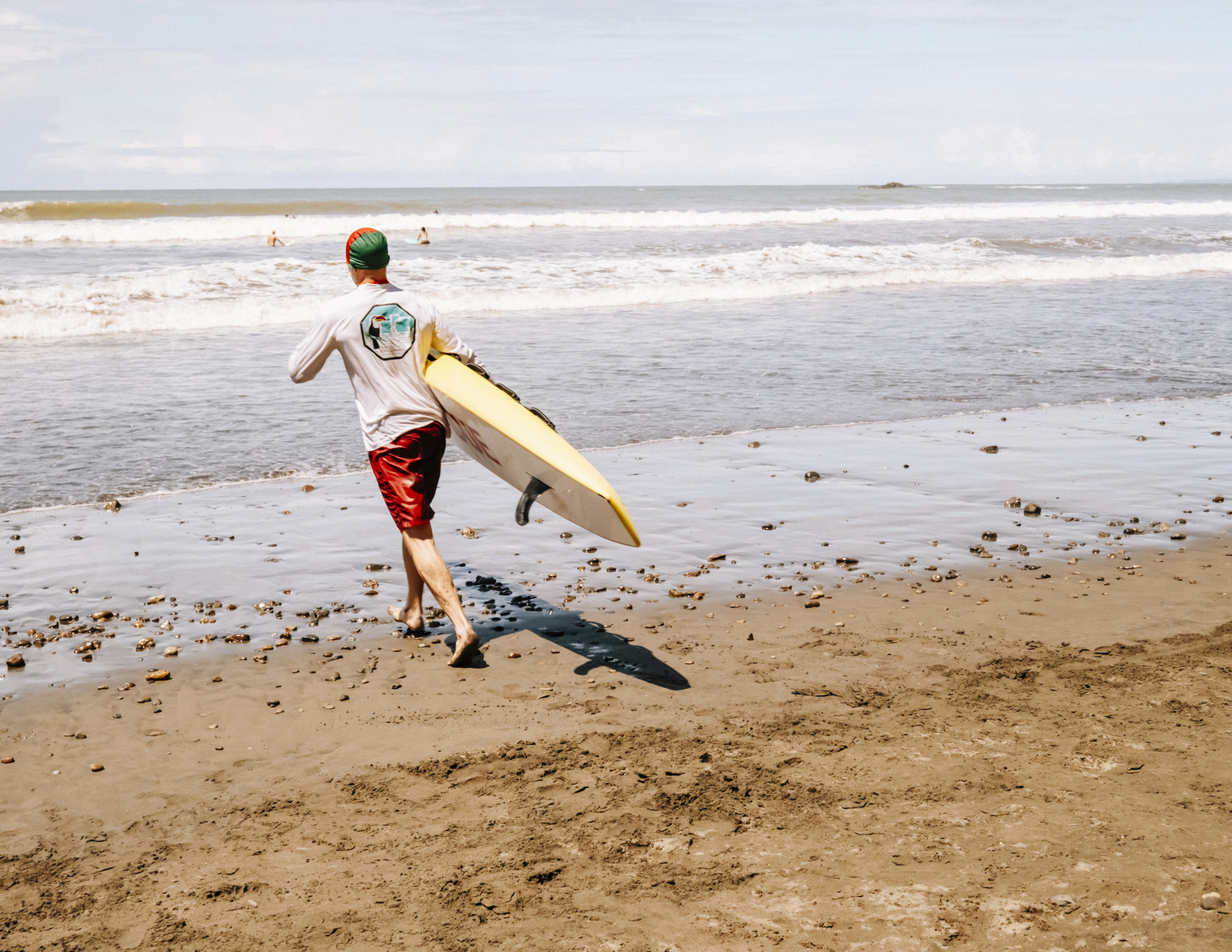 Costa Rica lifeguards gathered on the beach with rescue equipment